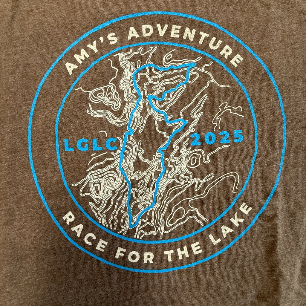 Brown t-shirt with 'Amy's Adventure Race for the Lake' graphic design featuring a map and text.