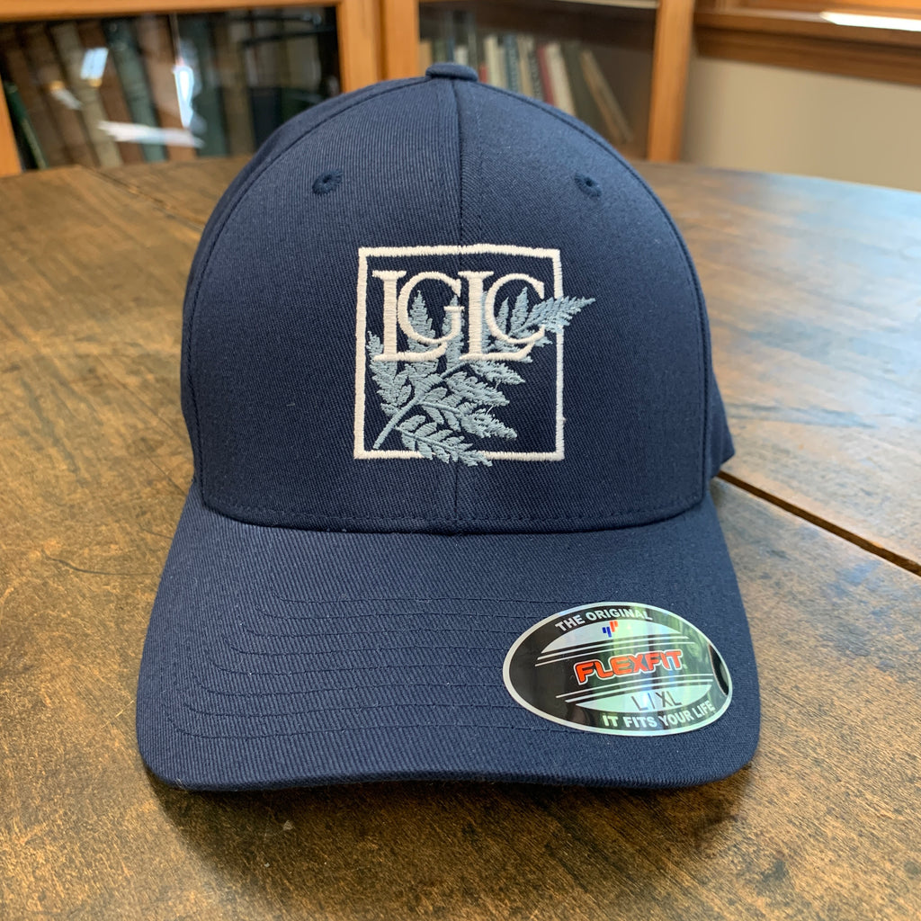 Navy blue cap with logo on a wooden surface