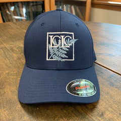 Navy blue cap with logo on a wooden surface