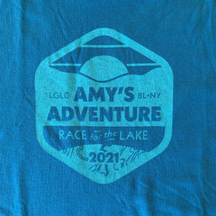 Close-up of Amy's Race logo with "2021" year included. Lighter blue screen printing on teal shirt.