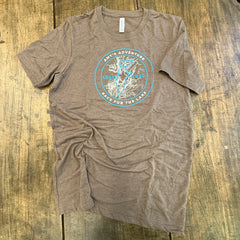 Brown t-shirt with a blue graphic on a wooden surface