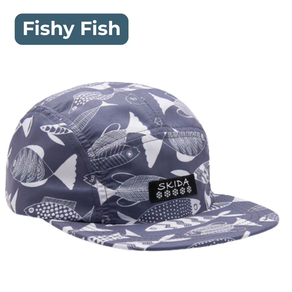 Brim hat with blue fabric patterned with white drawings of fish. Skida branding on front, labeled "Fishy Fish."