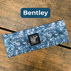 Blue patterned fabric rectangle with a LGLC brand label on a wooden surface