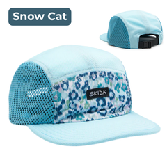 Light blue cap with leopard print pattern and 'Skida' logo on a white background. "Snow Cat"