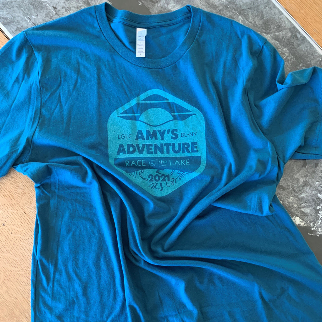 Teal blue shirt with Amy's Race logo screen printed on center front. 